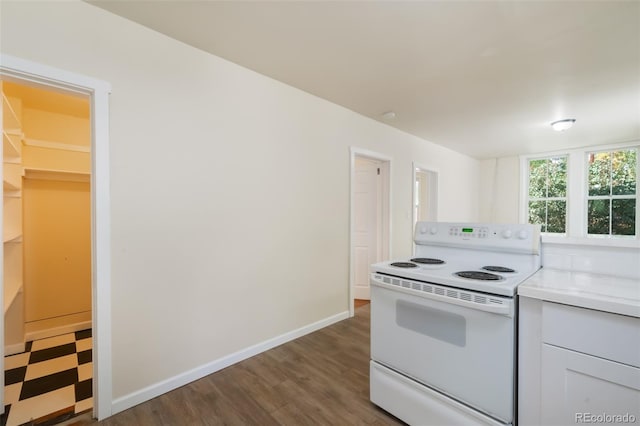 kitchen featuring white cabinets, white electric stove, and dark wood-type flooring