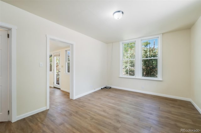 unfurnished room with wood-type flooring