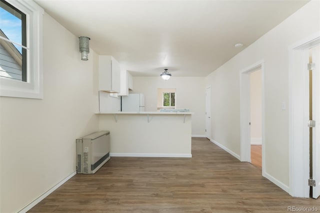 unfurnished living room featuring wood-type flooring