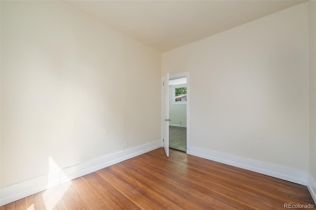 unfurnished room featuring hardwood / wood-style flooring