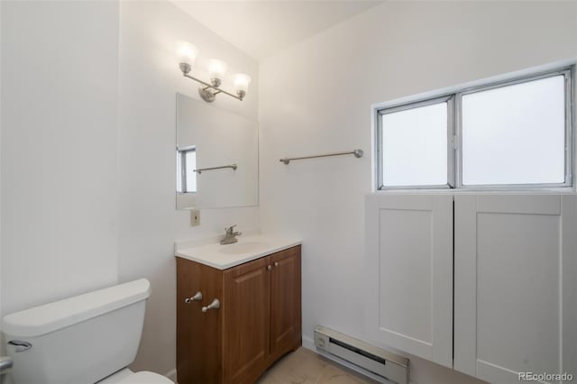 bathroom with tile patterned flooring, toilet, vanity, and a baseboard heating unit