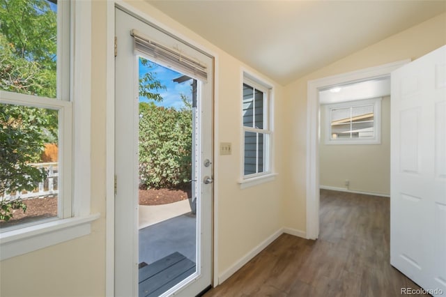 doorway to outside with dark wood-type flooring and vaulted ceiling