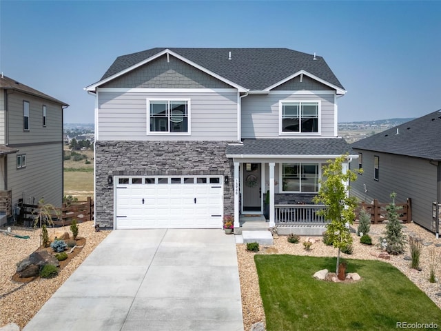 craftsman house with a garage, a porch, and a front lawn