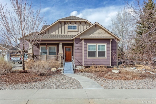 craftsman house featuring covered porch, a shingled roof, and board and batten siding