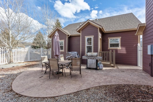 view of patio / terrace with a grill and fence