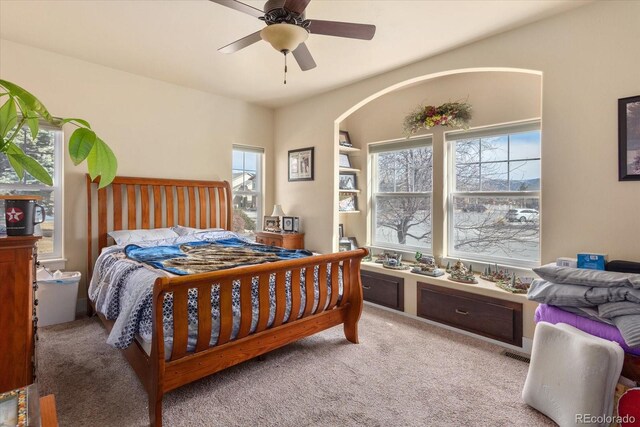 carpeted bedroom with ceiling fan and visible vents