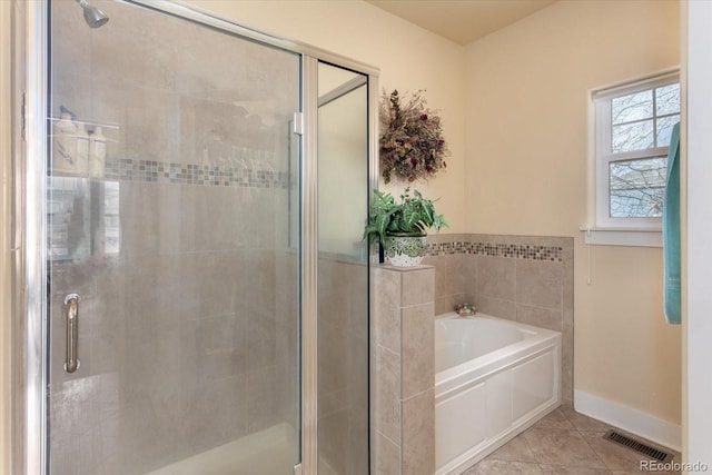 bathroom featuring visible vents, baseboards, a garden tub, tile patterned flooring, and a shower stall