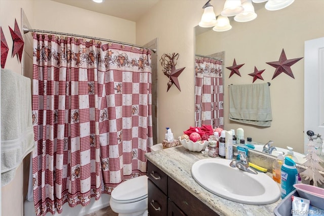 full bathroom featuring toilet, curtained shower, and vanity