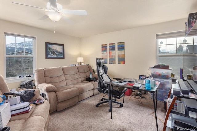 carpeted office featuring a ceiling fan