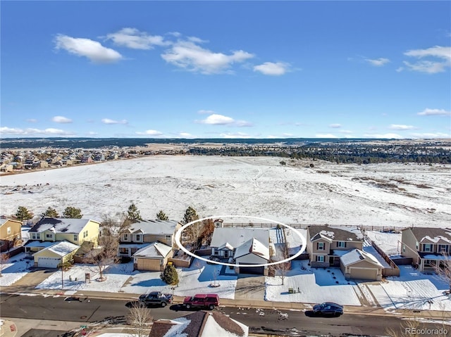 snowy aerial view with a residential view