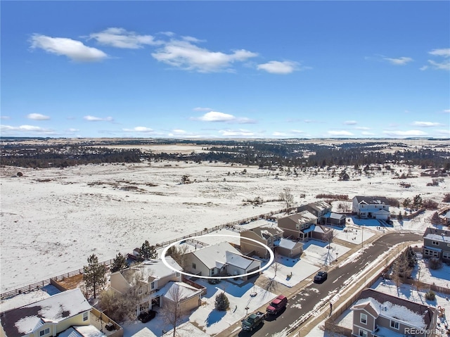 snowy aerial view with a residential view