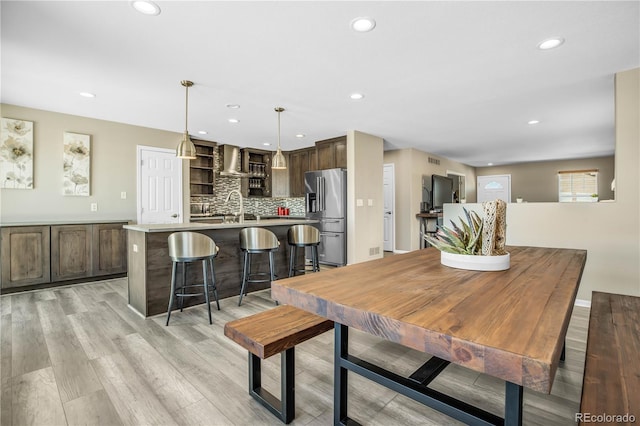 dining area with light wood-style floors, recessed lighting, and visible vents