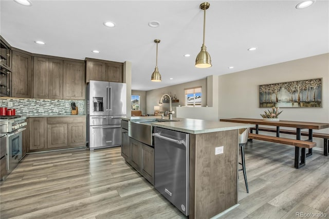 kitchen with recessed lighting, light wood-style flooring, and premium appliances