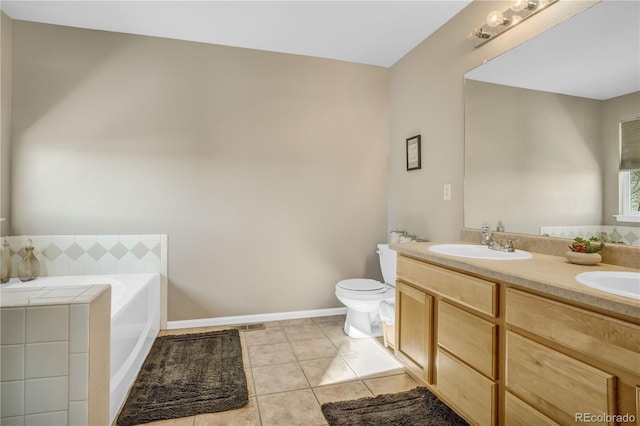 bathroom with a sink, double vanity, toilet, tile patterned floors, and a garden tub