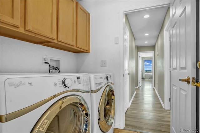 laundry area with cabinet space, washing machine and clothes dryer, recessed lighting, baseboards, and light wood-type flooring