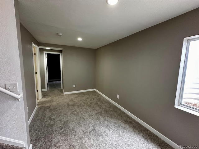 carpeted spare room with baseboards, recessed lighting, and a wealth of natural light