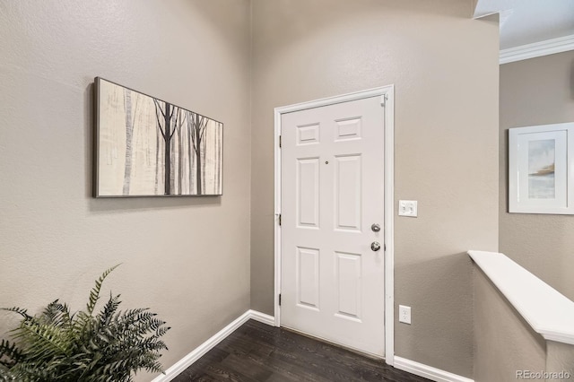 foyer entrance with baseboards, dark wood-style flooring, and crown molding