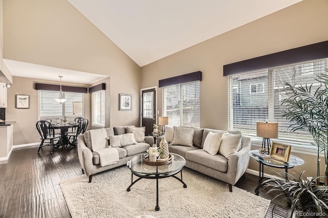 living area featuring dark wood finished floors, plenty of natural light, and baseboards