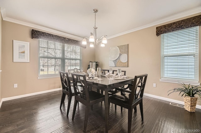 dining space featuring crown molding, dark wood-type flooring, and baseboards