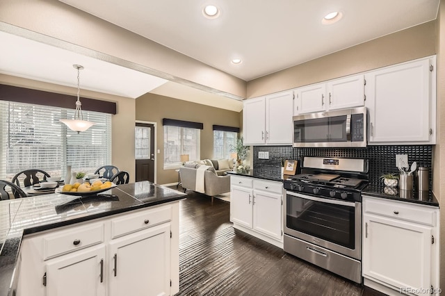 kitchen featuring stainless steel appliances, tasteful backsplash, dark wood-style floors, and white cabinets