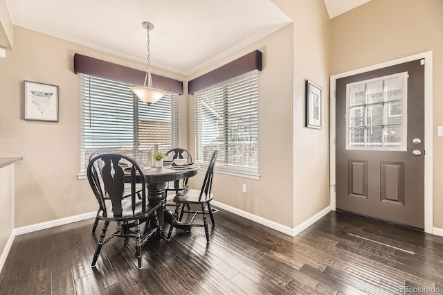 dining room featuring dark wood-type flooring and baseboards