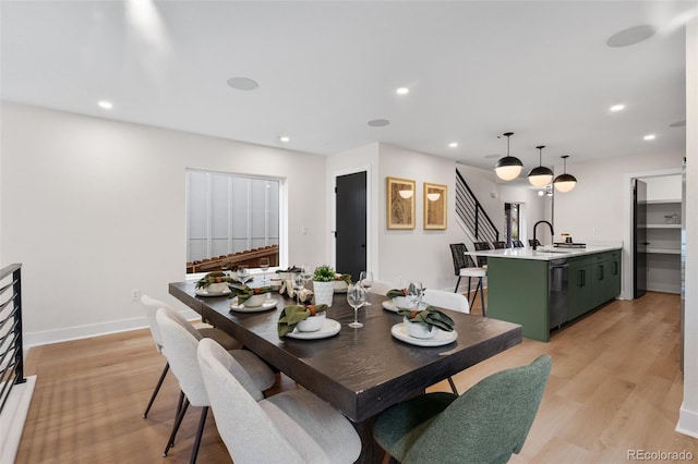 dining space featuring recessed lighting, light wood-type flooring, and baseboards