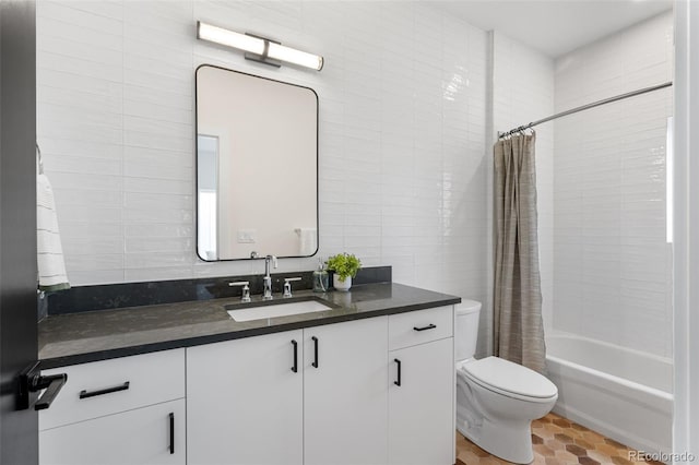 full bathroom featuring shower / tub combo with curtain, toilet, tile walls, and vanity