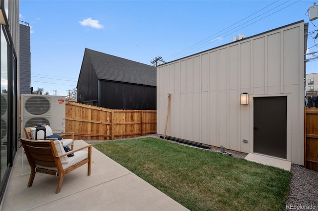 view of yard with ac unit, a patio, an outbuilding, and fence