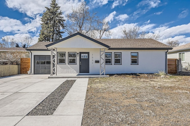 single story home with a garage, concrete driveway, fence, and a shingled roof