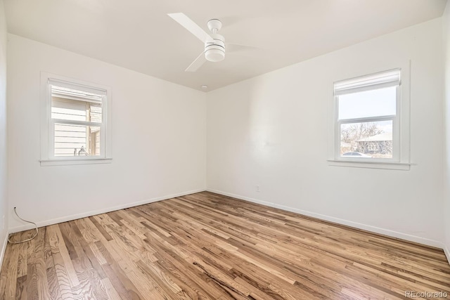 unfurnished room with light wood finished floors, baseboards, and a wealth of natural light