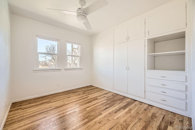 unfurnished bedroom with light wood finished floors, a closet, a ceiling fan, and baseboards