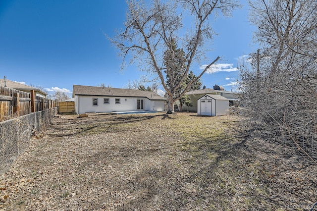 back of property with a patio area, an outdoor structure, a fenced backyard, and a storage shed