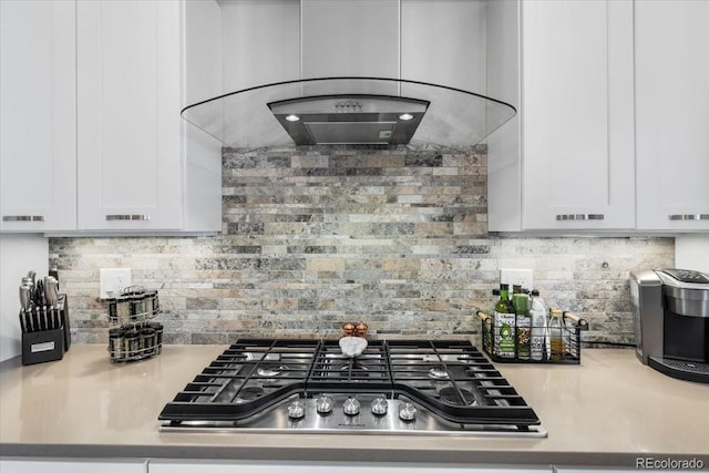3103 W 18th Ave, Denver, CO 80204 - kitchen with stainless steel gas cooktop, white cabinets, backsplash, and ventilation hood