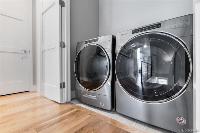 3103 W 18th Ave, Denver, CO 80204 - washroom with light wood-type flooring and washer and clothes dryer