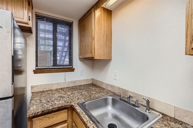 kitchen with sink and stainless steel refrigerator