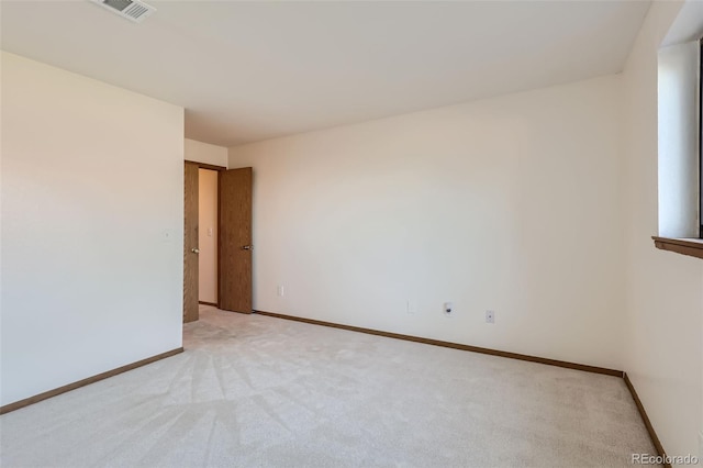 empty room featuring light carpet