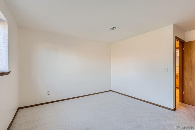 empty room featuring light carpet