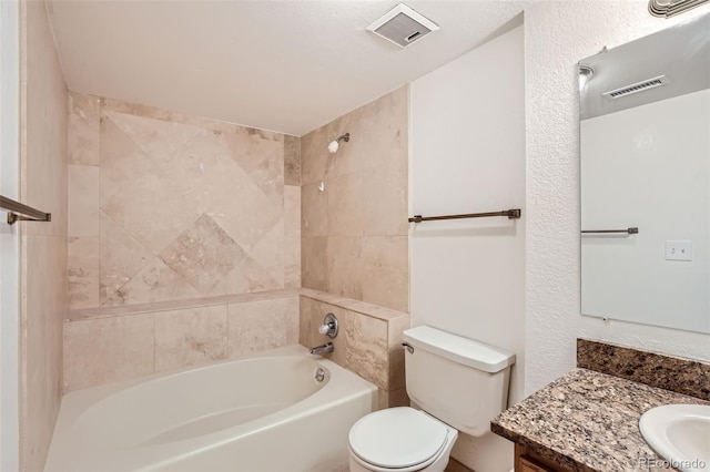 full bathroom featuring vanity, toilet, and tiled shower / bath