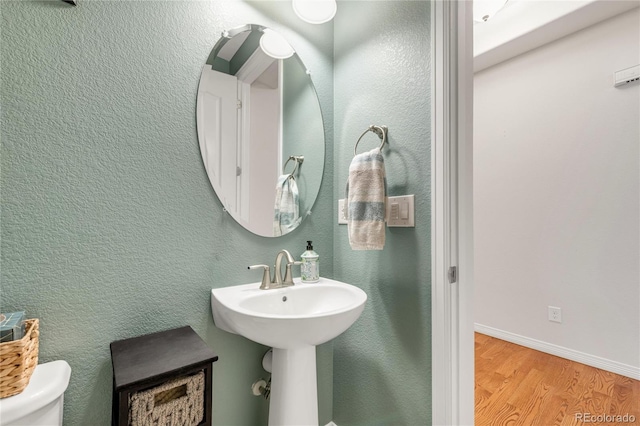 9904 Quintero St, Commerce City, CO 80022 - half bathroom with wood finished floors and toilet