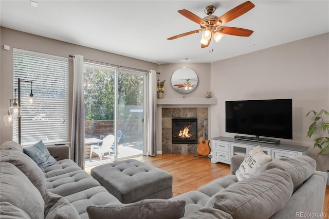 9904 Quintero St, Commerce City, CO 80022 - living area with ceiling fan, light wood-type flooring, and a fireplace