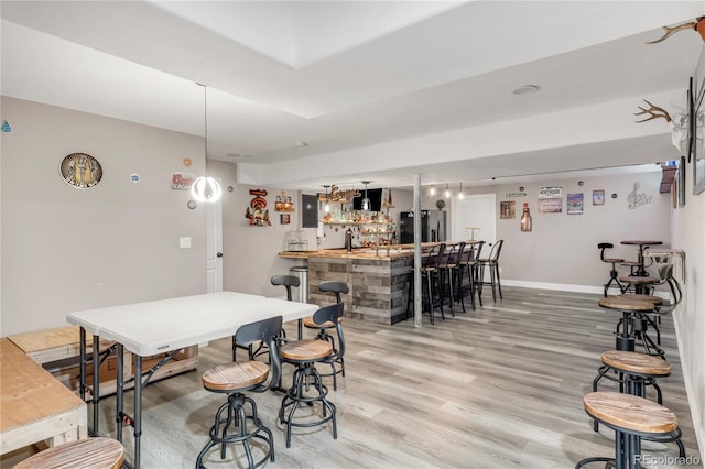 9904 Quintero St, Commerce City, CO 80022 - dining space featuring wet bar and light wood-type flooring