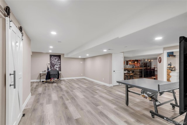 9904 Quintero St, Commerce City, CO 80022 - playroom featuring bar area, a barn door, light wood-style floors, and recessed lighting