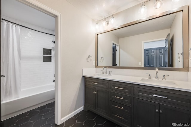 full bathroom featuring tile patterned flooring, double vanity, shower / bath combination with curtain, and a sink