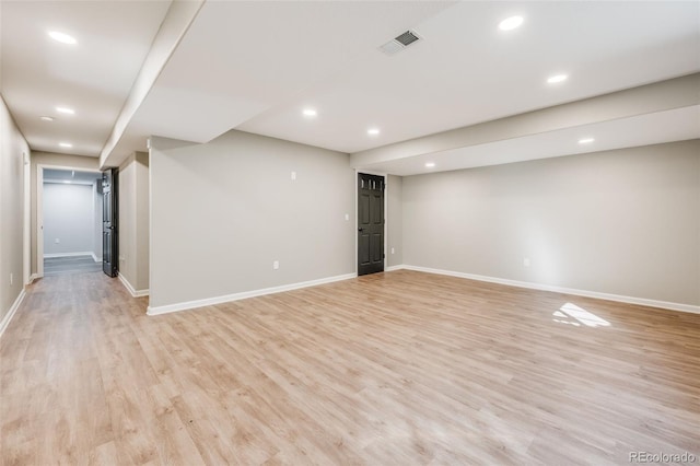 finished basement featuring recessed lighting, baseboards, visible vents, and light wood-type flooring