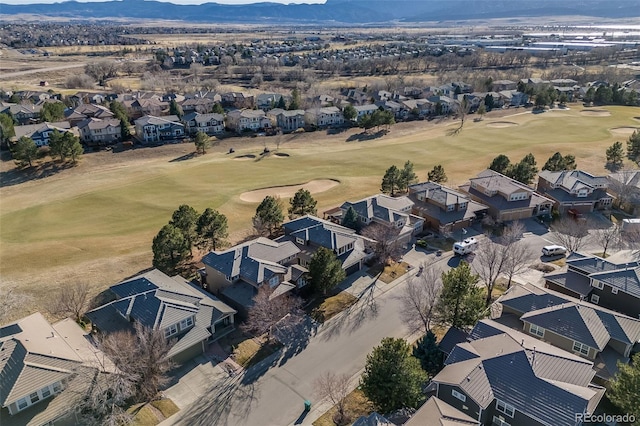 drone / aerial view featuring a mountain view, a residential view, and view of golf course