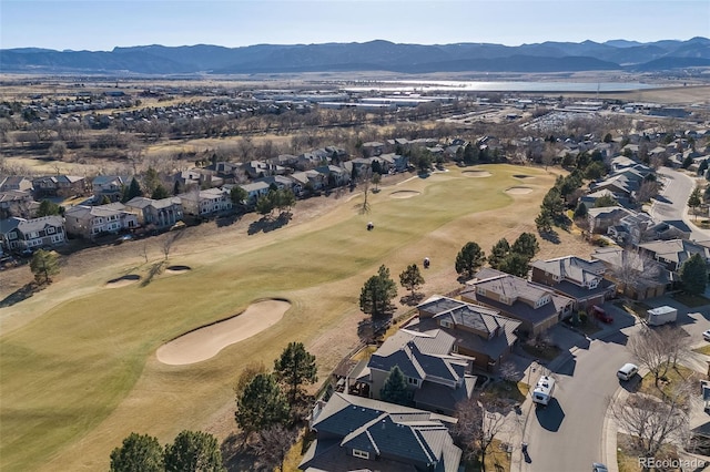 drone / aerial view featuring a residential view, a mountain view, and golf course view