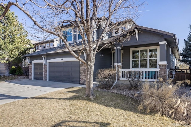 craftsman-style home featuring a garage, a porch, concrete driveway, and stone siding