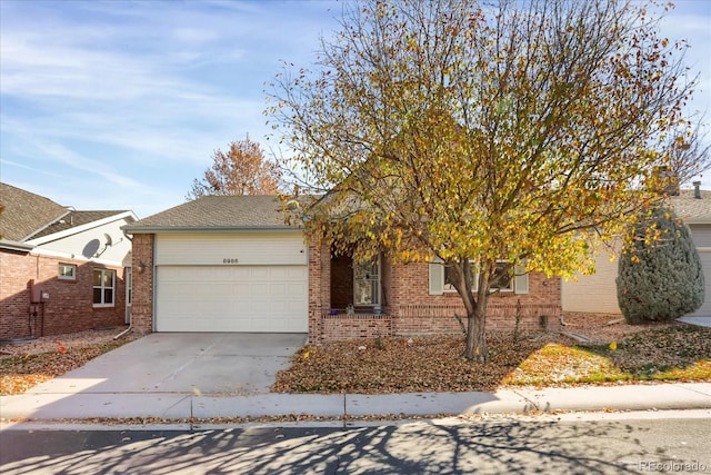 view of property hidden behind natural elements with a garage