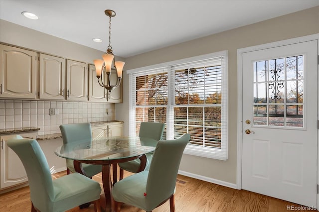 dining room featuring light hardwood / wood-style floors and a notable chandelier