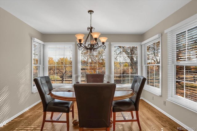 dining area featuring hardwood / wood-style flooring and a chandelier